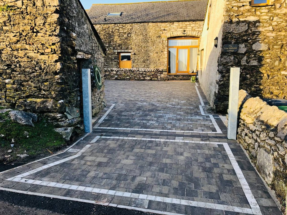 Finished courtyard driveway between traditional stone buildings